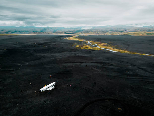Crashed military plane in black sand Solheimasandur beach. The US Navy DC-3 super bus airplane crash landed in Iceland. Solheimasandur beach, close to town Vik. High quality photo