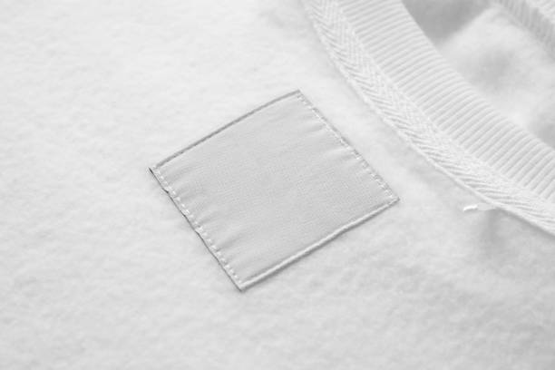 istock Blank white laundry care clothes label on fabric texture background 1447262115