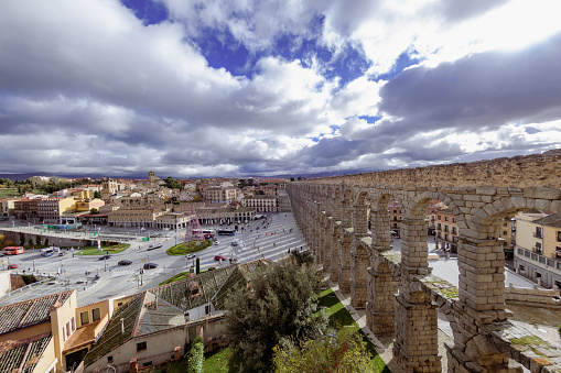 rays entering through the aqueduct of Segovia with cloudy sky and titl shift diorama effect