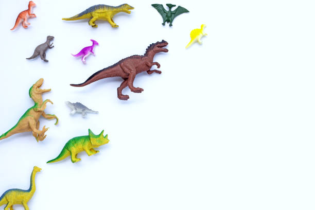 istock Plastic dinosaur toys on white background. Top view 1447264294