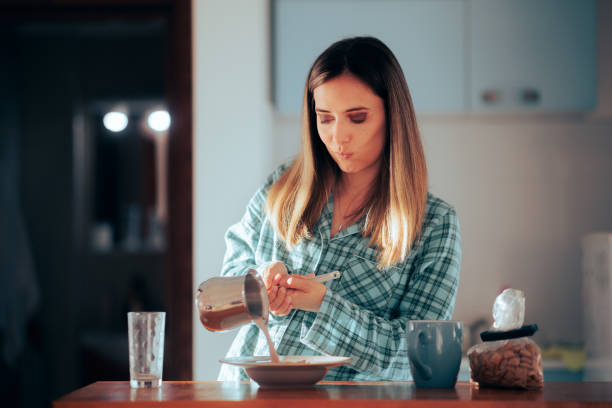 istock Woman Making Breakfast Pouring Milk Over Cereal 1447265075