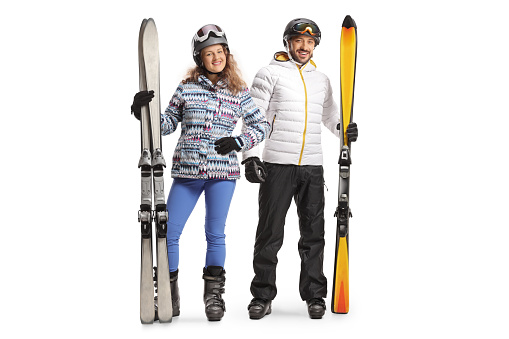 Young man and woman with skiing equipment isolated on white background