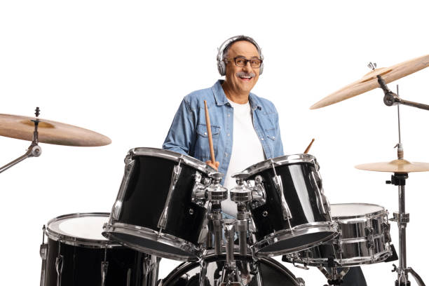 istock Smiling mature man with headphones playing drums 1447265964