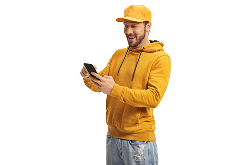 Guy with a yellow cap using a smartphone isolated on white background