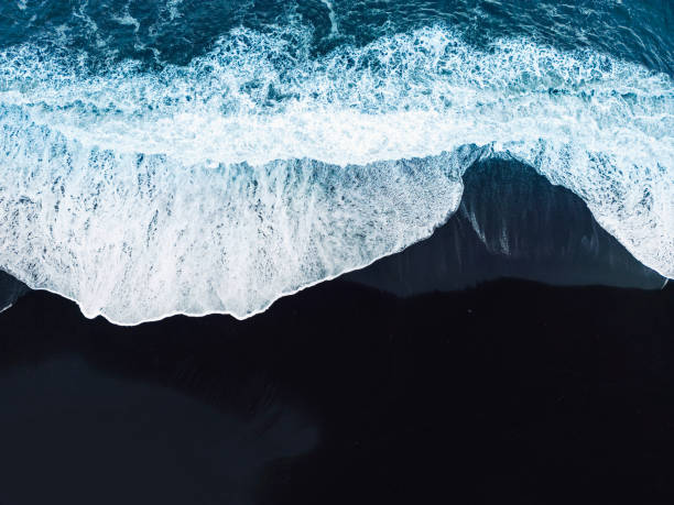 istock Directly above - Waves crashing on the black beach 1447267379