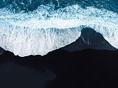 Directly above - Waves crashing on the black beach