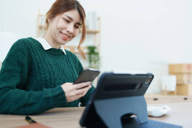 istock business owner or Asian male marketers are using smart phone and tablet computer in office work 1447268977