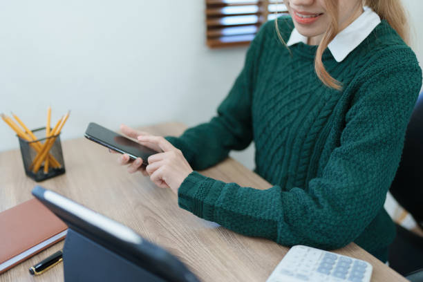 business owner or Asian male marketers are using smart phone and tablet computer in office work