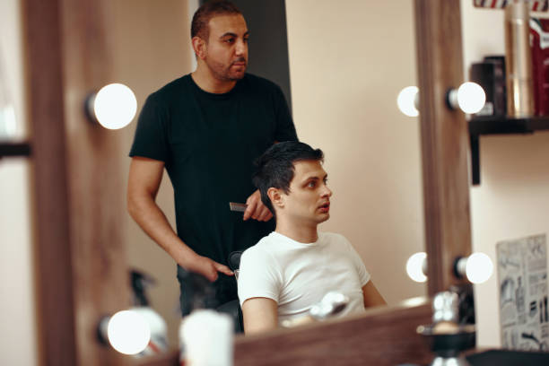 istock Barber and satisfied bearded man in front of the mirror 1447270330