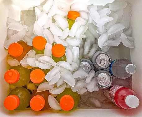Ice cold drinks inside a cooler.