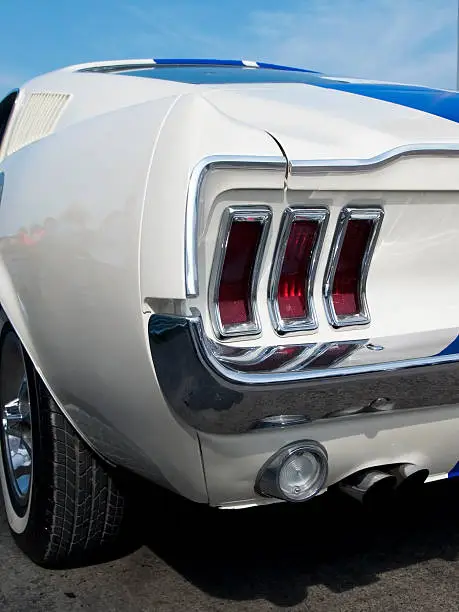 Rear detail of white, american sportscar from the sixties