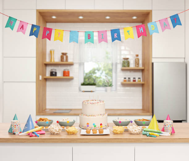 istock Kitchen decorated for a birthday party with cake and snacks 1447273222