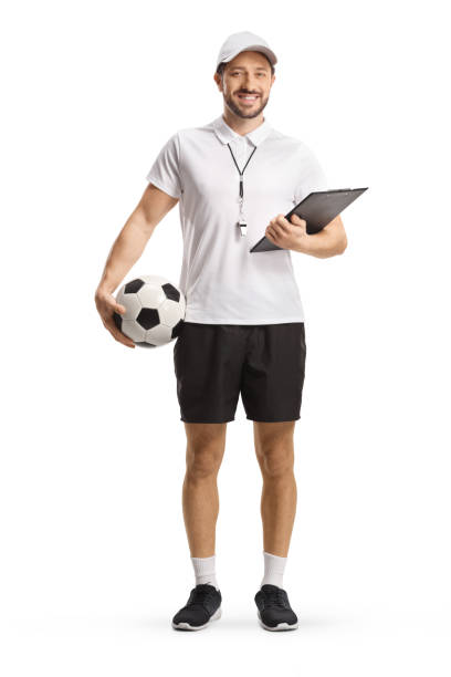 Full length portrait of a football coach holding a ball and a clipboard stock photo