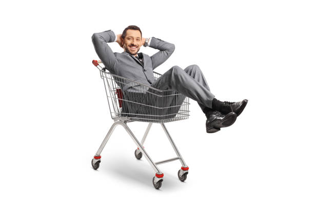 istock Young professional man sitting inside a shopping cart 1447273418