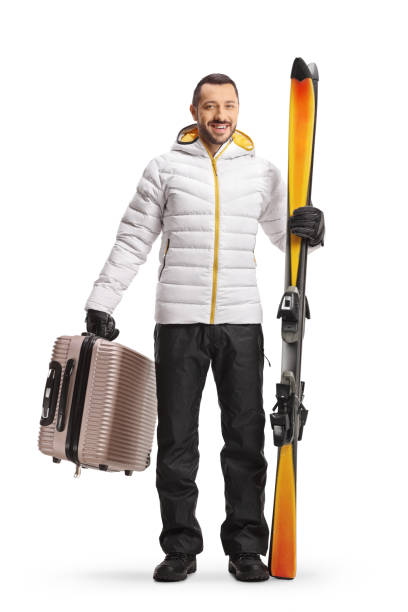 istock Young man with a suitcase and pair of skiis 1447273426