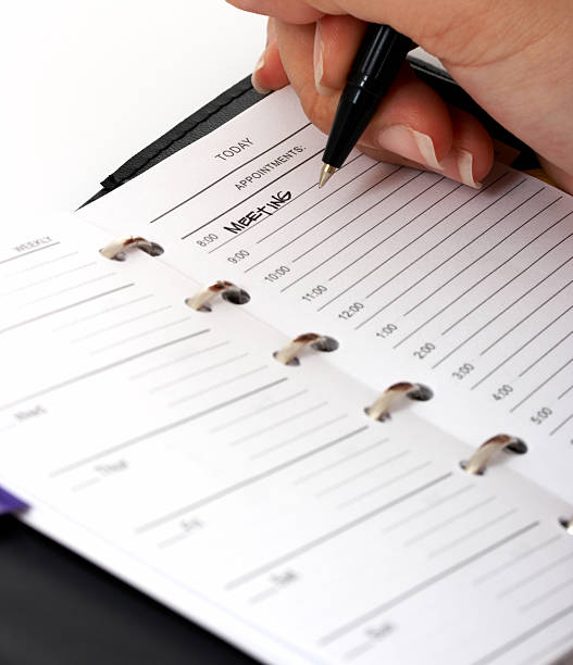 istock Woman's hands writing with pen in a professional organizer 144727478