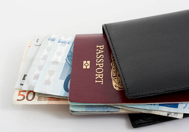 istock A black wallet with passport and paper bills 144727490
