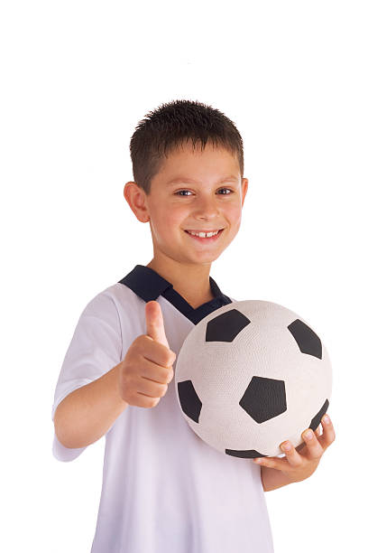 istock young boy holding football 144727672