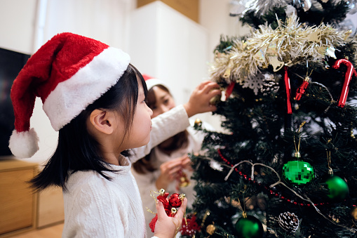 Child decorating Christmas decoration