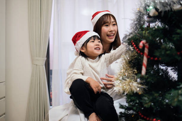 istock Mother and daughter decorating Christmas decoration 1447284247