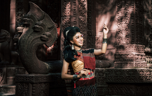 Young female Actress wearing beautiful ancient costumes, in ancient monuments, dramatic style. Perform on legend love popular story, Thai Isan folktale called Phadaeng and Nang-ai in acient site