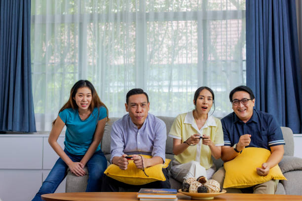 istock Friends enjoy playing console game together at home. 1447287509