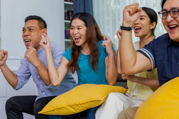 istock Friends enjoy watching media at home together. 1447288630
