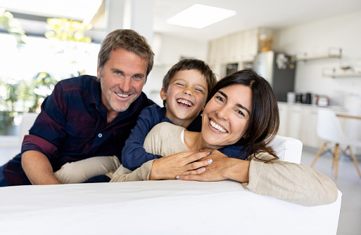 Portrait of a loving Latin American family smiling at home and looking at the camera - lifestyle concepts