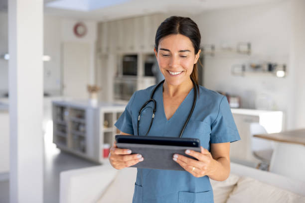 istock Female doctor making a house call and using a tablet computer 1447289494