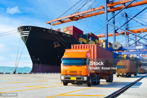 Container Shipping Orange Color Truckload With A Container At A Harbor Container Port Terminal Container Delivery Stock Photo - Download Image Now