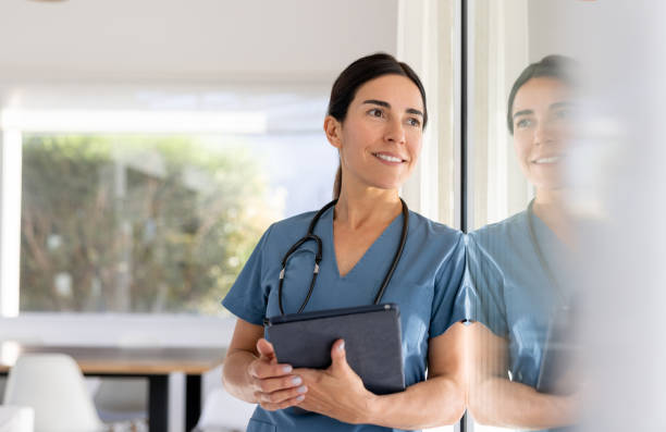 istock Thoughtful doctor on a house call looking at the window 1447289647