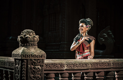 Young female Actress wearing beautiful ancient costumes, in ancient monuments, dramatic style. Perform on legend love popular story, Thai Isan folktale called Phadaeng and Nang-ai in acient site