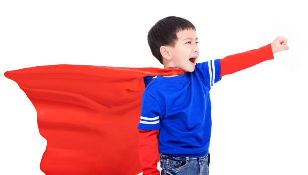 istock Happy kid in red super hero cape and mask 1447289846