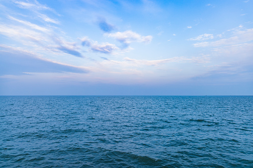 Rain cloud over the ocean horizon with sailboat in Miami Florida.