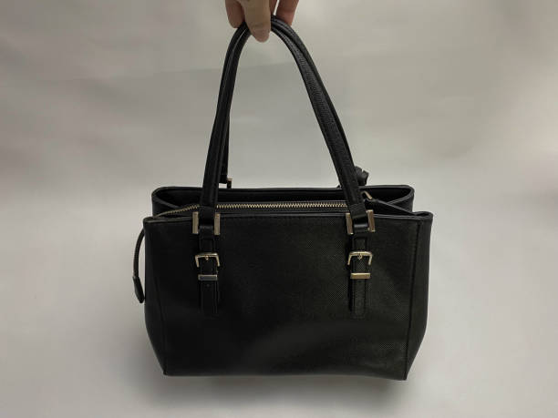 istock Back view of women's black leather bag on white background. 1447295909