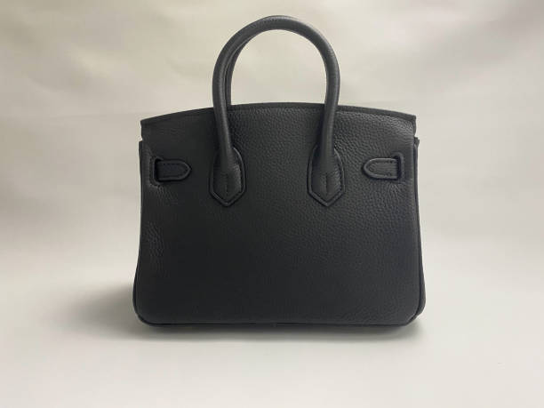 istock Back view of women's black leather bag on white background 1447295984