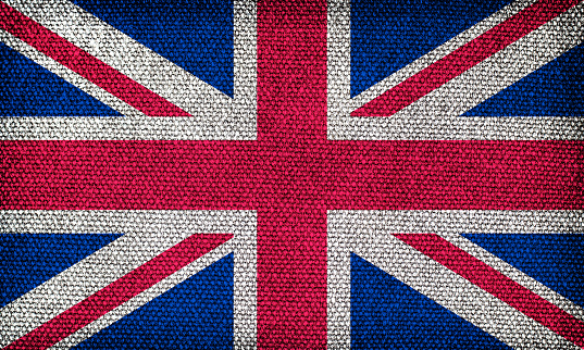 Flag of Great Britain with the texture of rough fabric. Image of the English flag.