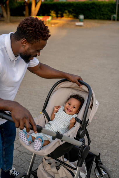 istock Young african american man with his kid in the park 1447300021