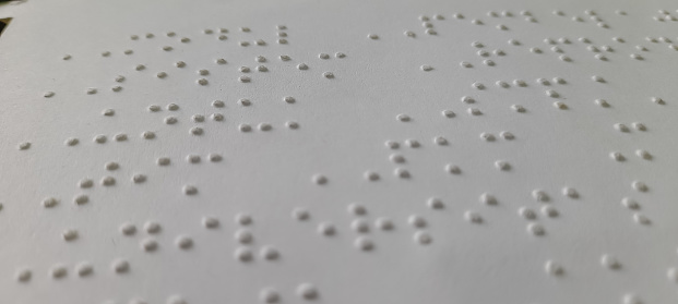 Braille letters designed to be read through the sense of touch for the blind or visually impaired.