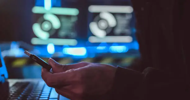 Photo of A hacker is stealing data from a computer.