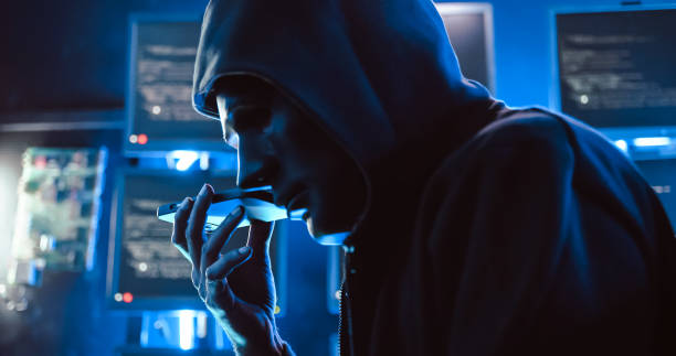 istock A hacker wearing a mask to cover his face is using computer to hack data to get ransom from victims. 1447300582