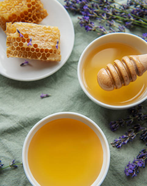 istock Jar with honey and fresh lavender flowers 1447300632