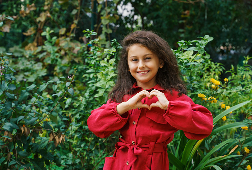 Cute little girl portrait in flower garden