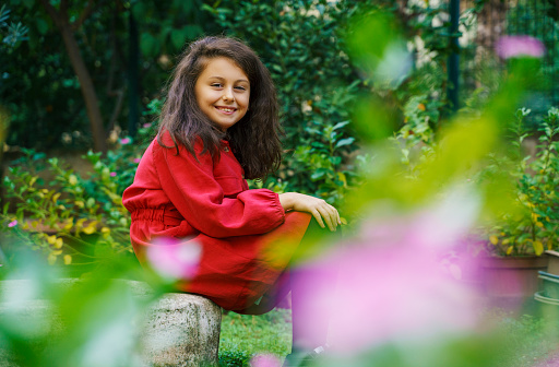 Cute little girl portrait in flower garden