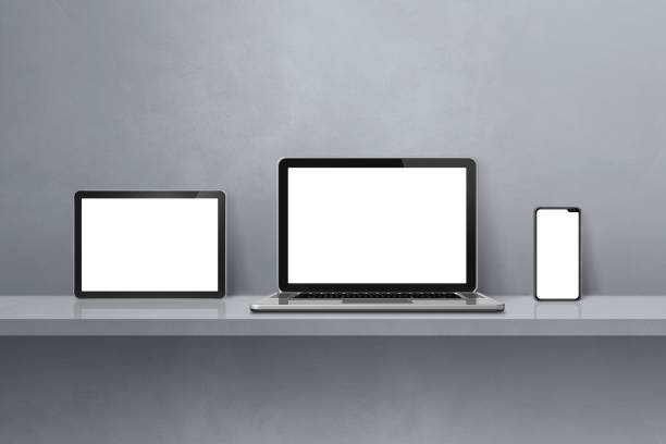 istock Laptop, mobile phone and digital tablet pc on grey wall shelf. Horizontal background 1447305747