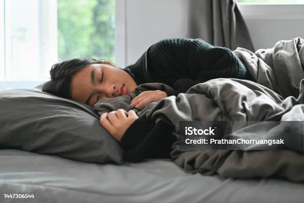 Carefree Teenage Woman Sleeping In Comfortable Bed And Covered With Blanket People And Rest Concept Stock Photo - Download Image Now