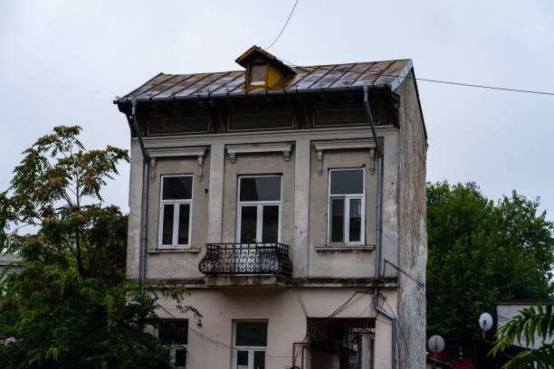 istock Old two-floor building next to trees in Bucharest, Romania 1447306954