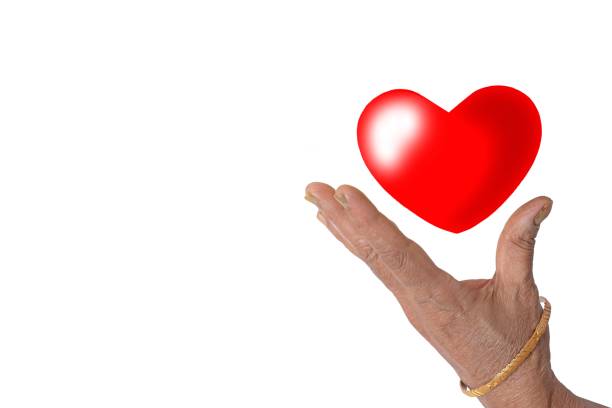 Red heart floating in hand on white background