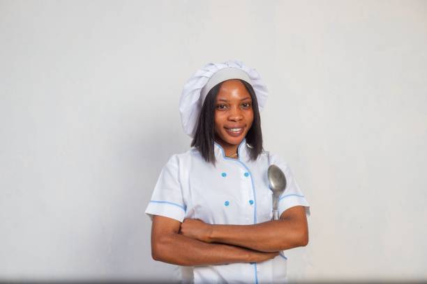 istock Beautiful chef against white background holding a spoon 1447308306