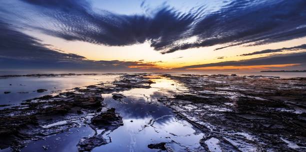 istock Mesmerizing sunset over the sea with rocky coast 1447308933